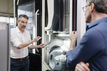 Businessmen in factory, having a meeting, discussing solutions - DIGF09767