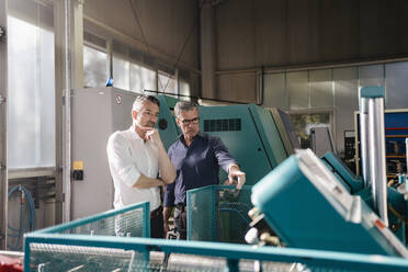 Businessmen in factory, having a meeting, discussing solutions - DIGF09773