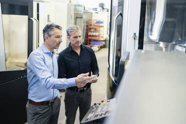 Businessmen in factory, having a meeting, discussing solutions - DIGF09785