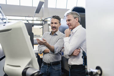 Businessmen in factory, having a meeting, discussing solutions - DIGF09814