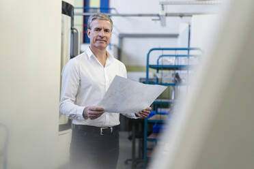 Senior employee checking production plans - DIGF09818