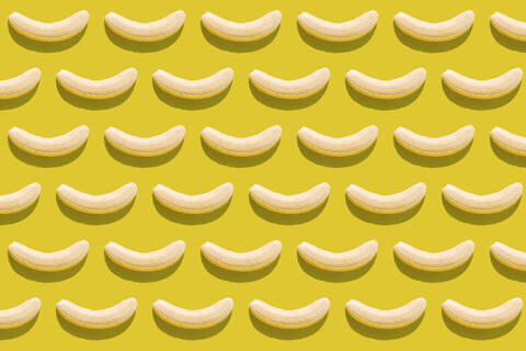 3D illustration of peeled bananas on yellow background stock photo