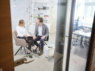 Businessman and businesswoman having a meeting in modern office - CVF01607