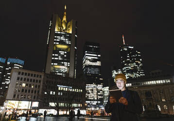Man using tablet in the city at night - AHSF02267