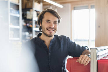 Portrait of smiling man in a factory - DIGF09870