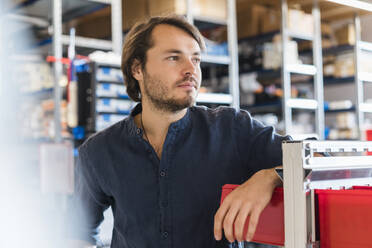 Portrait of pensive man in a factory - DIGF09871