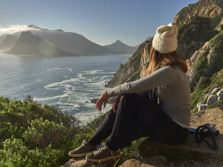 Woman enjoying the view from the top of a mountain, Chapman's Peak Drive, South Africa - VEGF01906