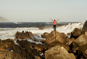 Man on the rocks in front of the ocean. Tsitsikamma National Park, South Africa - VEGF01935