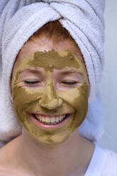 Portrait of laughing teenage girl with facial mask - LBF03046