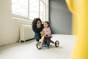 Happy mother with daughter on balance bicycle - JOSEF00282