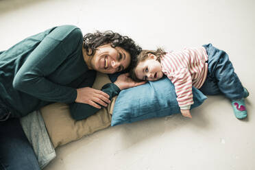 Happy mother with daughter lying on the floor - JOSEF00297