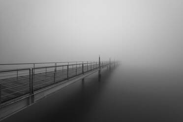 Portugal, Lisbon, Tagus River walkway shrouded in thick fog - RPSF00288