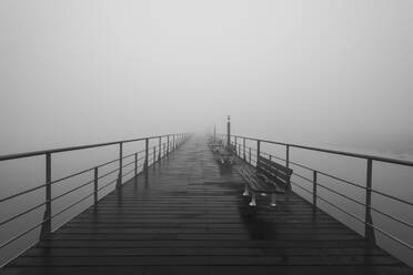 Portugal, Lisbon, Tagus River walkway shrouded in thick fog - RPSF00289