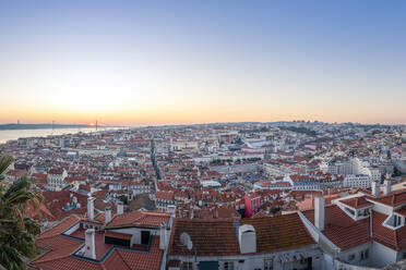 Portugal, Lisbon, Clear sky over city buildings seen from Sao Jorge Castle at sunset - RPSF00295