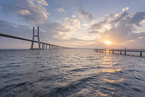 Portugal, Lisbon, Vasco da Gama Bridge at moody sunrise - RPSF00296