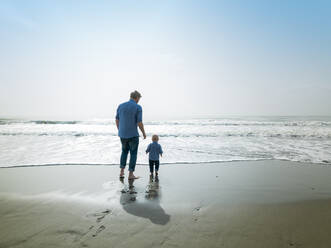 Father and son on a beach day, Bajondillo Beach in Torremolinos, - CAVF79073