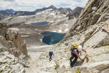 Women climb couloir above Pierre Lakes, Elk Mountains, Colorado - CAVF79088