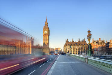 Double-decker bus passes on Westminster Bridge, in front of Westminster Palace and clock tower of Big Ben (Elizabeth Tower), London, England, United Kingdom - CAVF79196