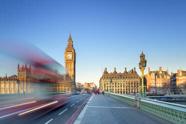 Double-decker bus passes on Westminster Bridge, in front of Westminster Palace and clock tower of Big Ben (Elizabeth Tower), London, England, United Kingdom - CAVF79198