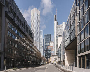 Germany, Hesse, Frankfurt, City street with downtown skyscrapers in background - AHSF02305