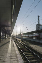 Germany, Hesse, Frankfurt, Train station at sunset - AHSF02321