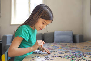 Girl doing a jigsaw at home - LVF08844