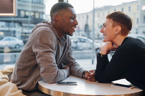 Smiling young couple in a cafe stock photo
