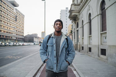 Portrait of young man standing on bicycle lane in the city, Milan, Italy - MEUF00488