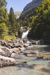 Spain, Province of Huesca, Small waterfall on clear mountain river - FVSF00216