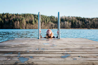 Woman breathing whilst cold water ice swimming in the sea in winter - CAVF79404