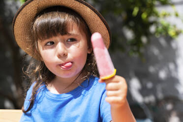 Portrait of little girl eating homemade strawberry ice cream - GEMF03606