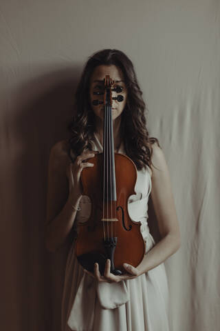 Woman holding violin stock photo