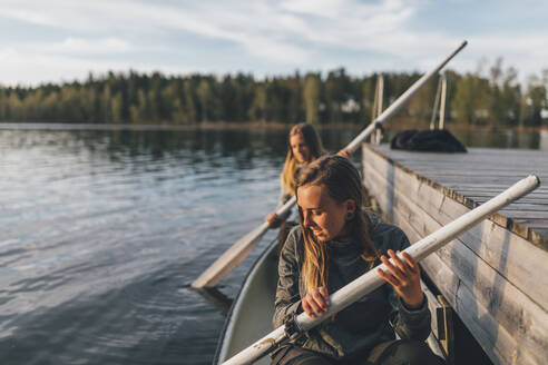 Zwei junge Frauen beim Bootfahren auf dem See - GUSF03745