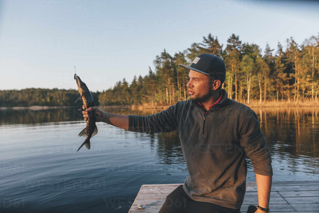 Man with fish caught on line hi-res stock photography and images