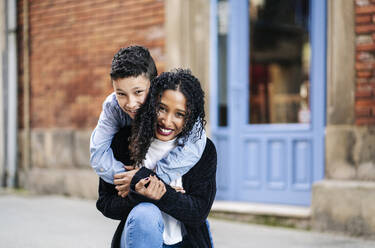 Portrait of happy mother and her son on the street - DGOF00906