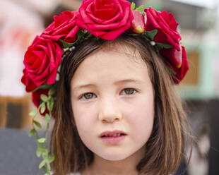 Portrait of a serious little girl with a wreath of roses in her hair - CAVF79570