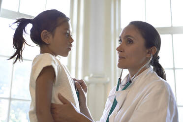 Allgemeinmediziner mit Stethoskop bei der Untersuchung eines jungen Mädchens - CAVF79760