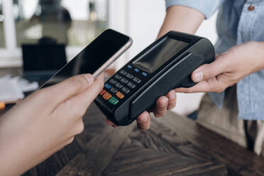 Paying bill through smartphone using NFC technology. - CAVF79775
