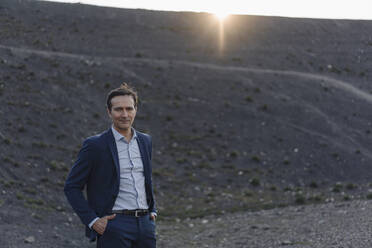 Portrait of a confident mature businessman on a disused mine tip - JOSEF00442