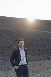 Portrait of a confident mature businessman on a disused mine tip - JOSEF00443