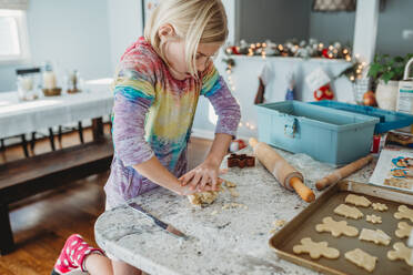 Girl kneading dough for cookies - CAVF79856