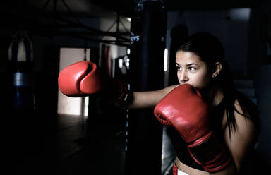 Young woman practicing boxing at the gym - CAVF79863