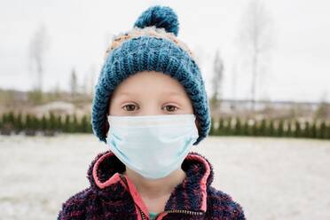 Young boy with face mask on protecting himself from flu and virus - CAVF80061