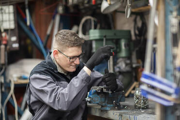 Plumber male working in a workshop - CAVF80252