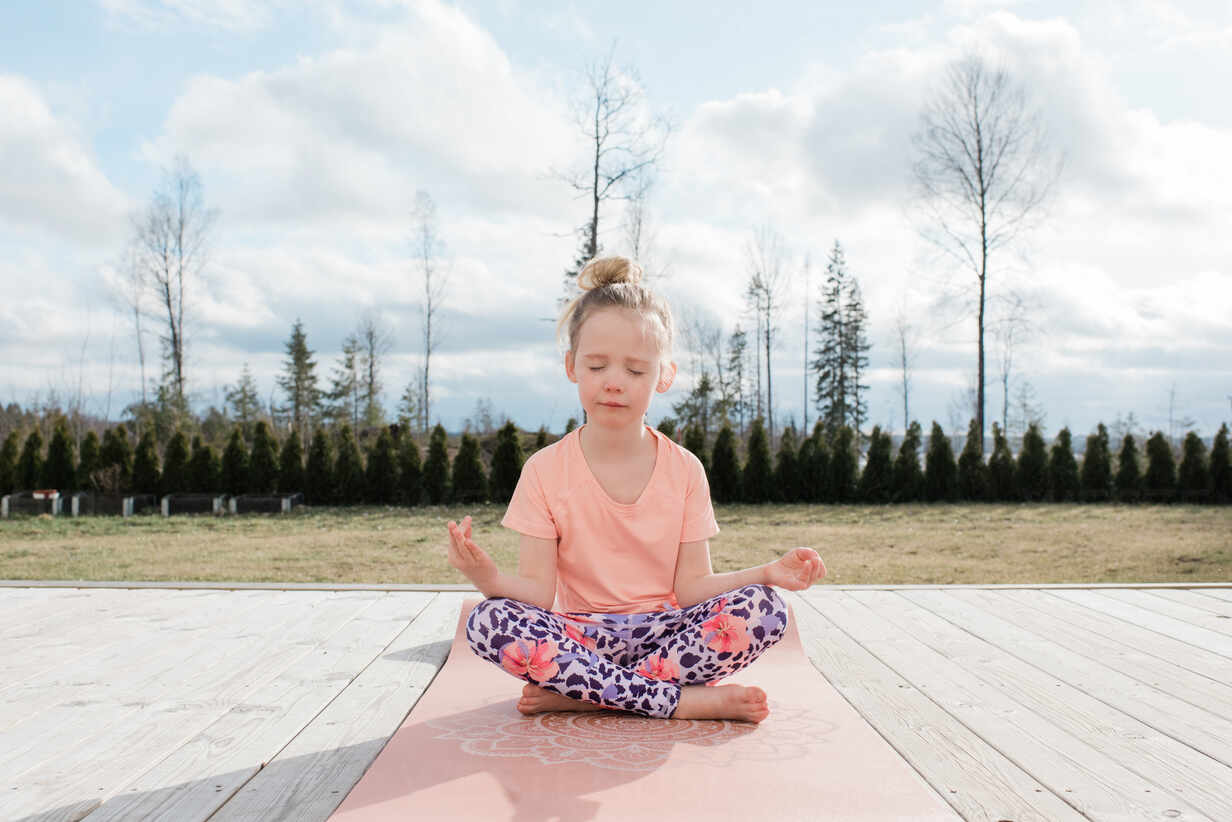 Teen girl doing yoga at home - a Royalty Free Stock Photo from