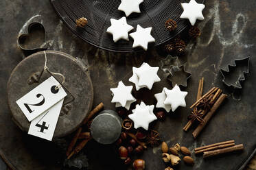 Rustic baking sheet, cinnamon sticks, star shaped Christmas cookies, cookie cutters, nuts and metal gift box - ASF06613