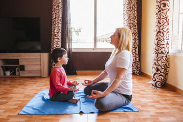 Mother and son doing yoga together at home - LJF01511