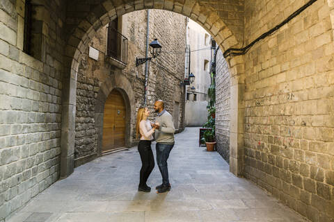 Couple dancing in an alley of Gothic Quarter, Barcelona, Spain stock photo