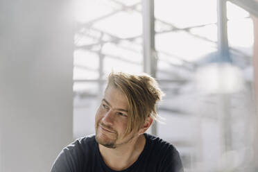 Portrait of a confident bearded man at the window - JOSEF00535