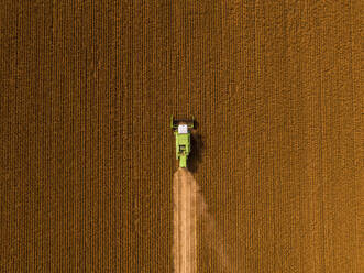 Aerial view of combine harvester on a field of soybean - NOF00081